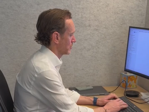 Ben Wells working at his desk in the Bain office
